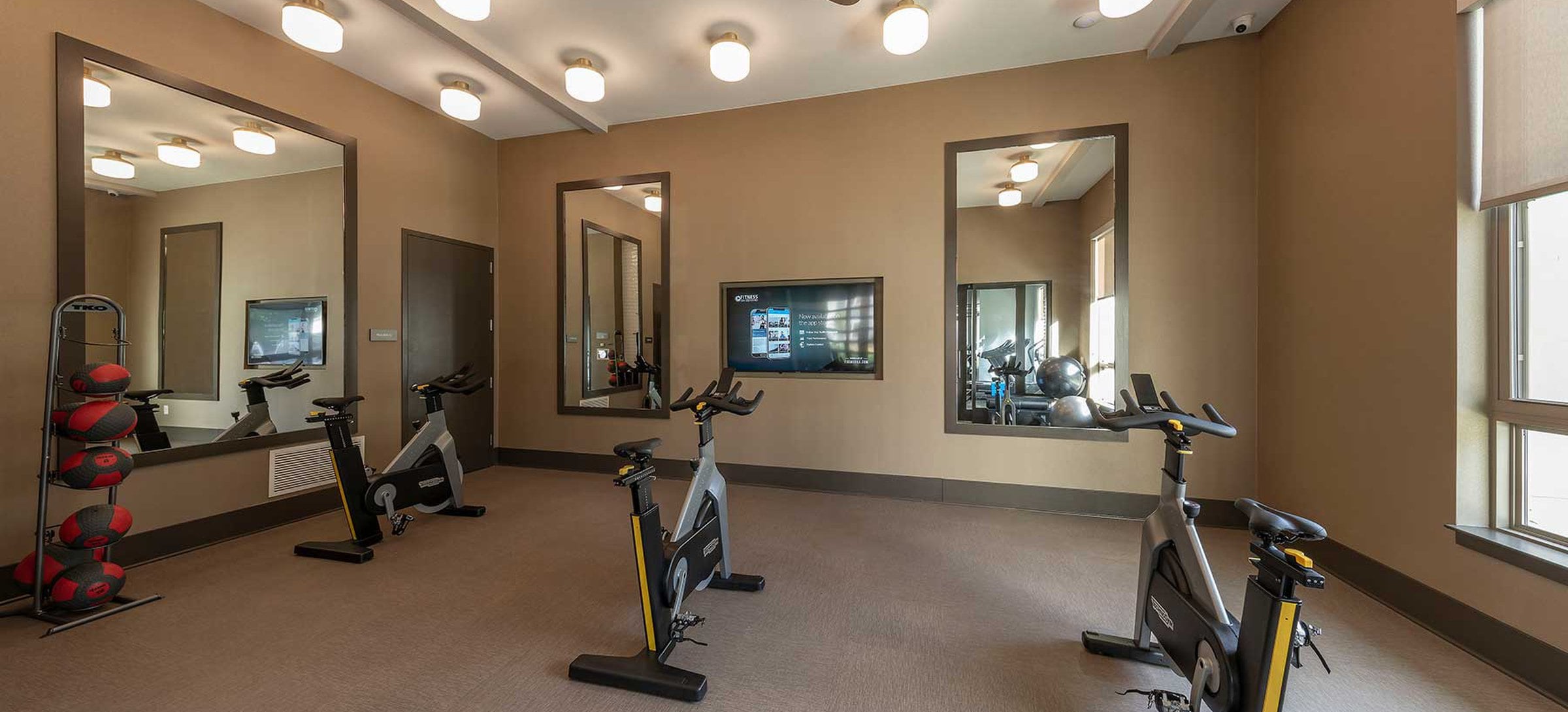 East building fitness studio with spin bikes and virtual fitness programming