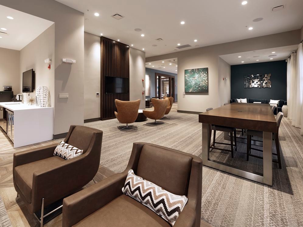 Resident lounge with entertaining kitchen, flat screen televisions and seating