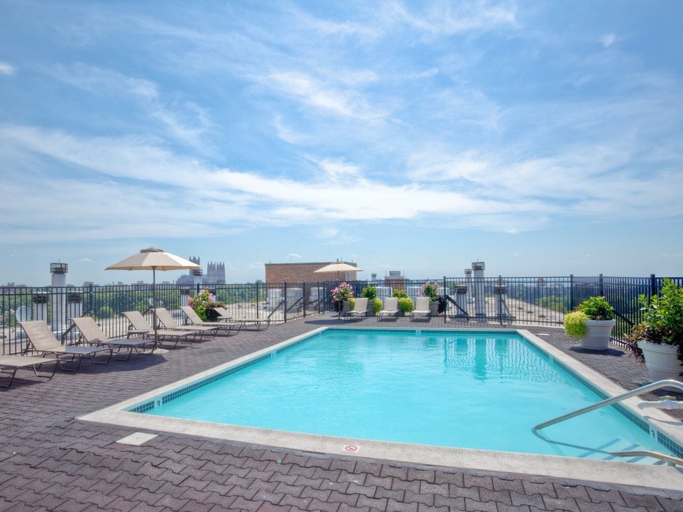 Rooftop pool and sundeck with lounge seating