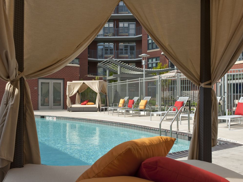 Swimming pool and sundeck with lounge seating and cabanas