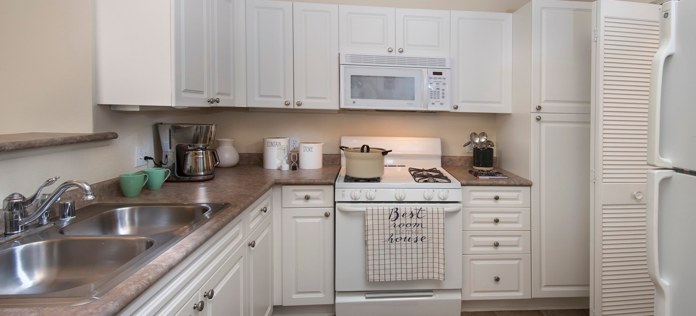 Classic Package I kitchen with white cabinetry, white appliances, laminate countertops, and tile flooring