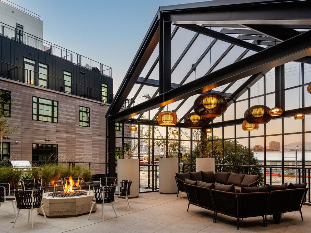 Rooftop terrace with lounge seating, firepit, and views