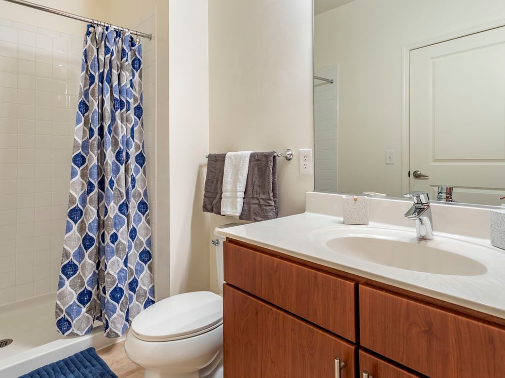 Newly renovated apartment homes feature baths with cherry cabinetry, white quartz countertops and hard surface flooring