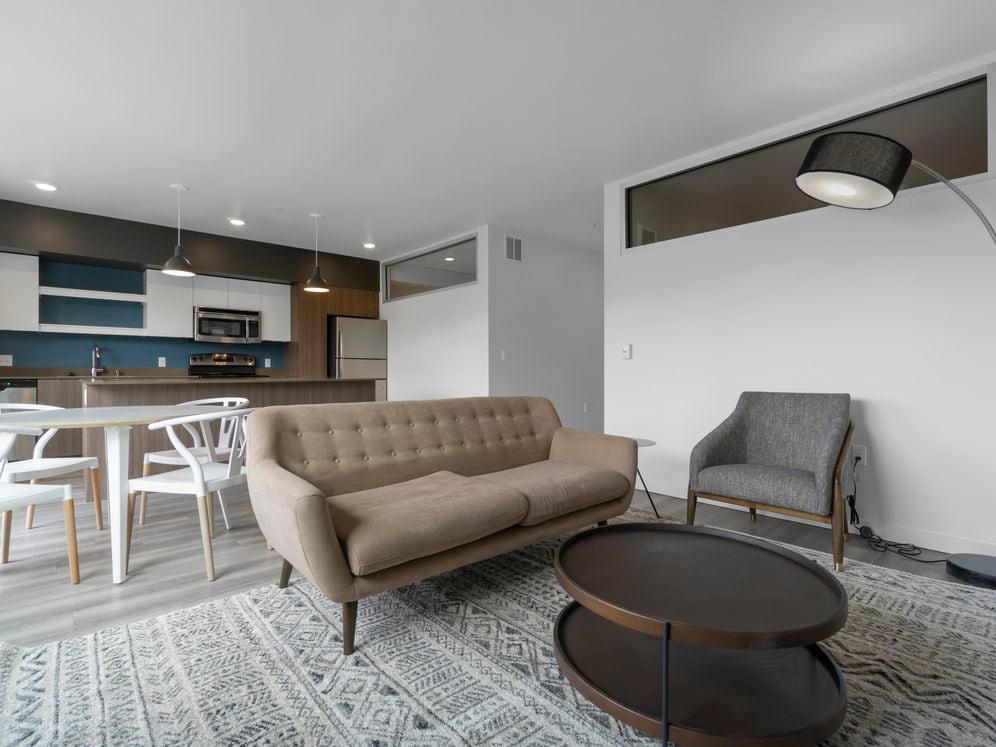 Furnished+ apartment homes come outfitted with a sofa, side chair, side table, coffee table, dining set, TV stand and 50" Television (Representative Image – exact items and style of furnishings may vary)