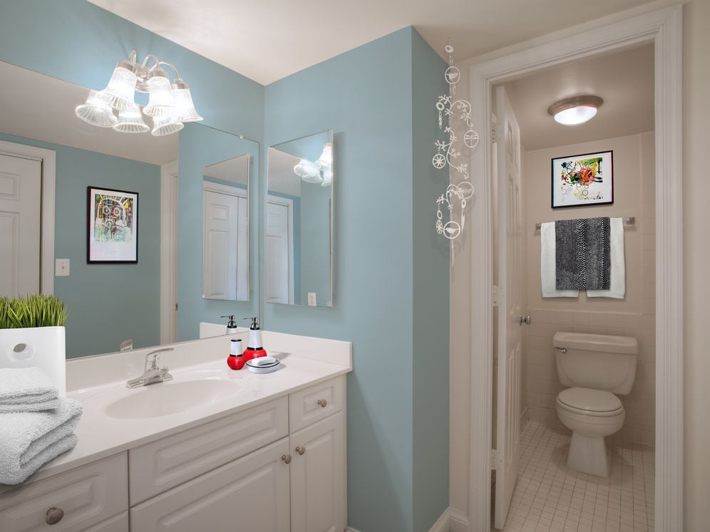 Bathroom with white cabinetry, white countertop and tile flooring