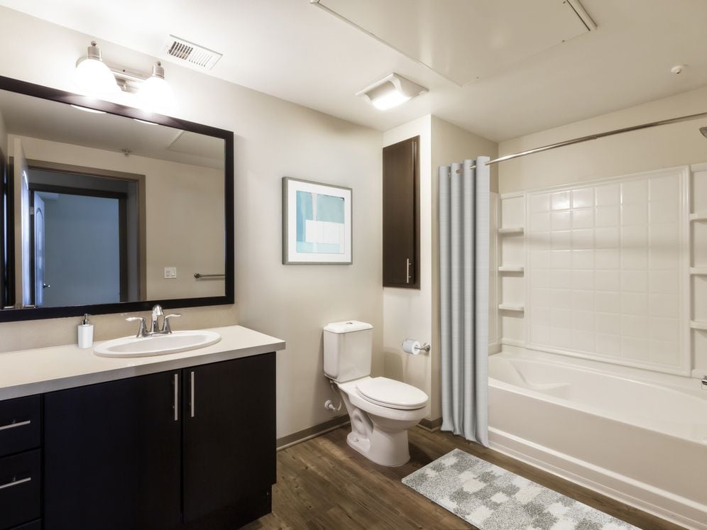 Classic Collection bath with beige quartz countertops, espresso cabinetry, and hard surface flooring