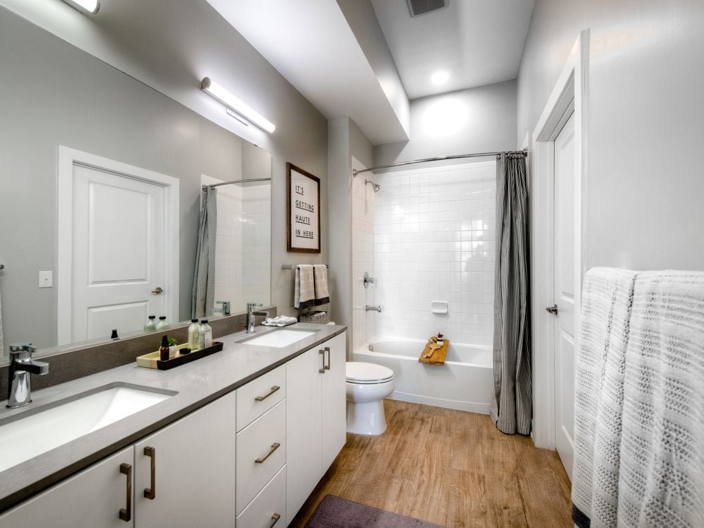 Scheme 1 dual vanity bath with quartz countertop, hard surface flooring and modern fixtures