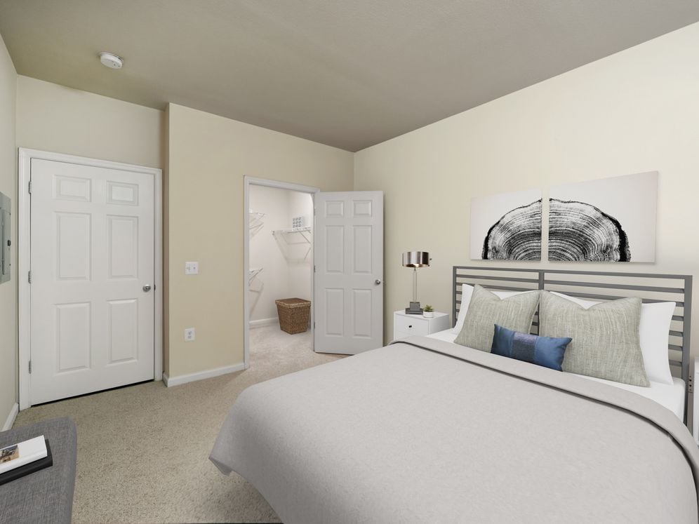 Renovated II bedroom with carpeted flooring and walk-in closet
