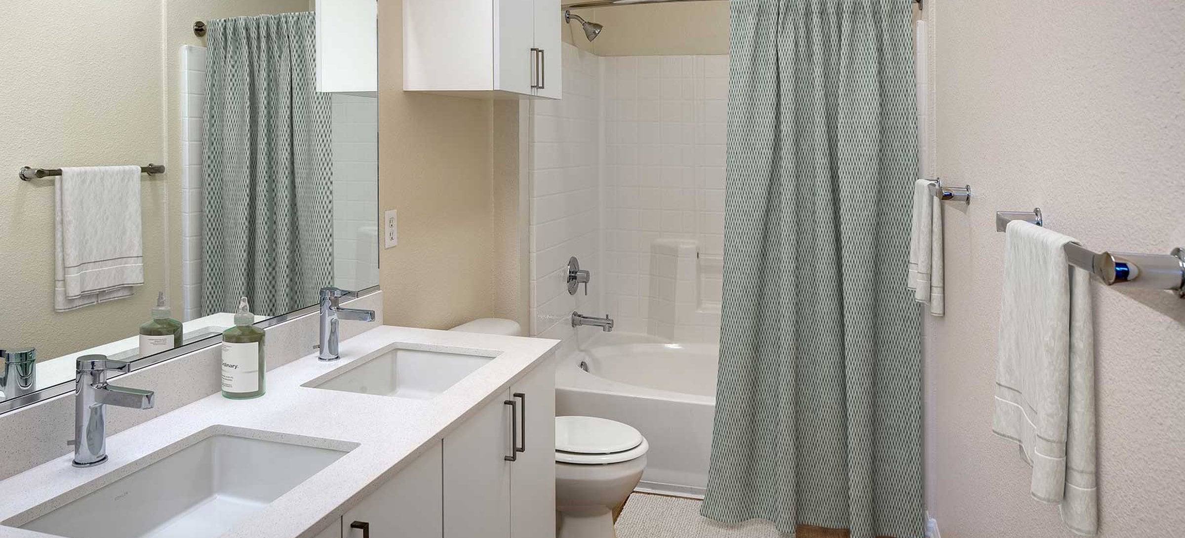 Renovated Package I bathroom featuring white cabinetry, white quartz countertops, and hard surface flooring