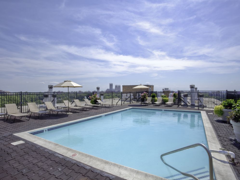 Rooftop swimming pool and sundeck with lounge seating