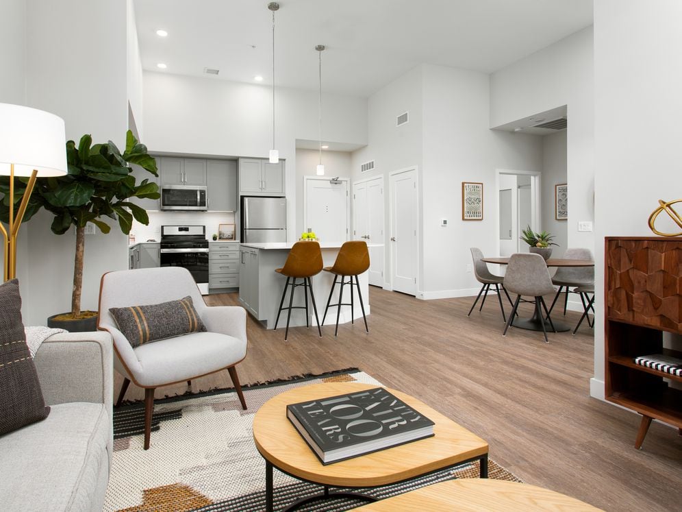 Apartments with hard surface flooring in kitchen, living, and dining areas