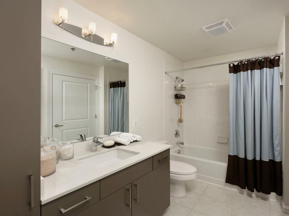 Bathroom with white countertop and tile flooring