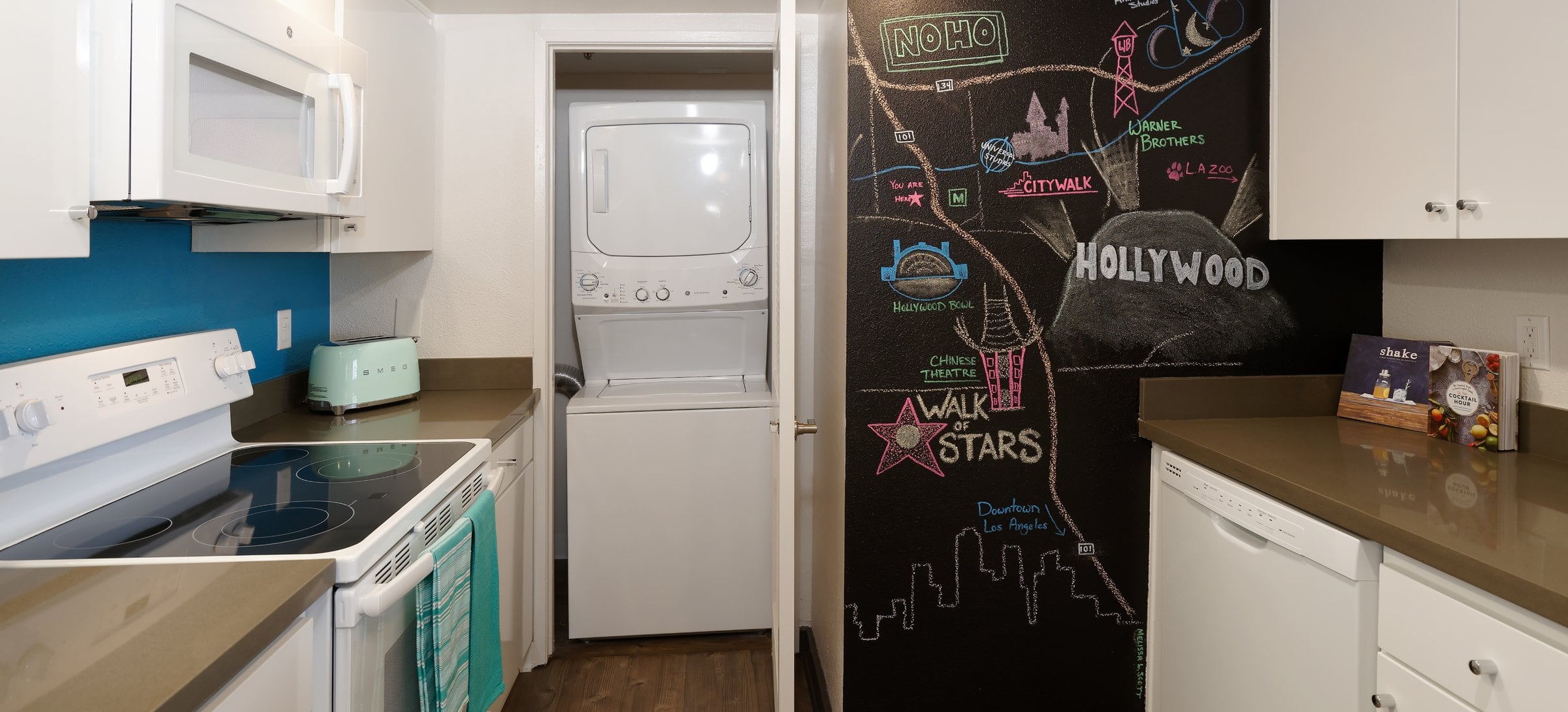 Standard Apartment Kitchen with Chalkboard Accent Wall and Washer Dryer