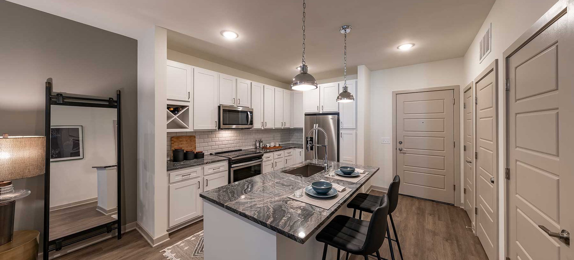 East Classic II kitchen with white cabinetry, marbled granite countertops, stainless steel appliances, tile backsplash, and hard surface plank flooring