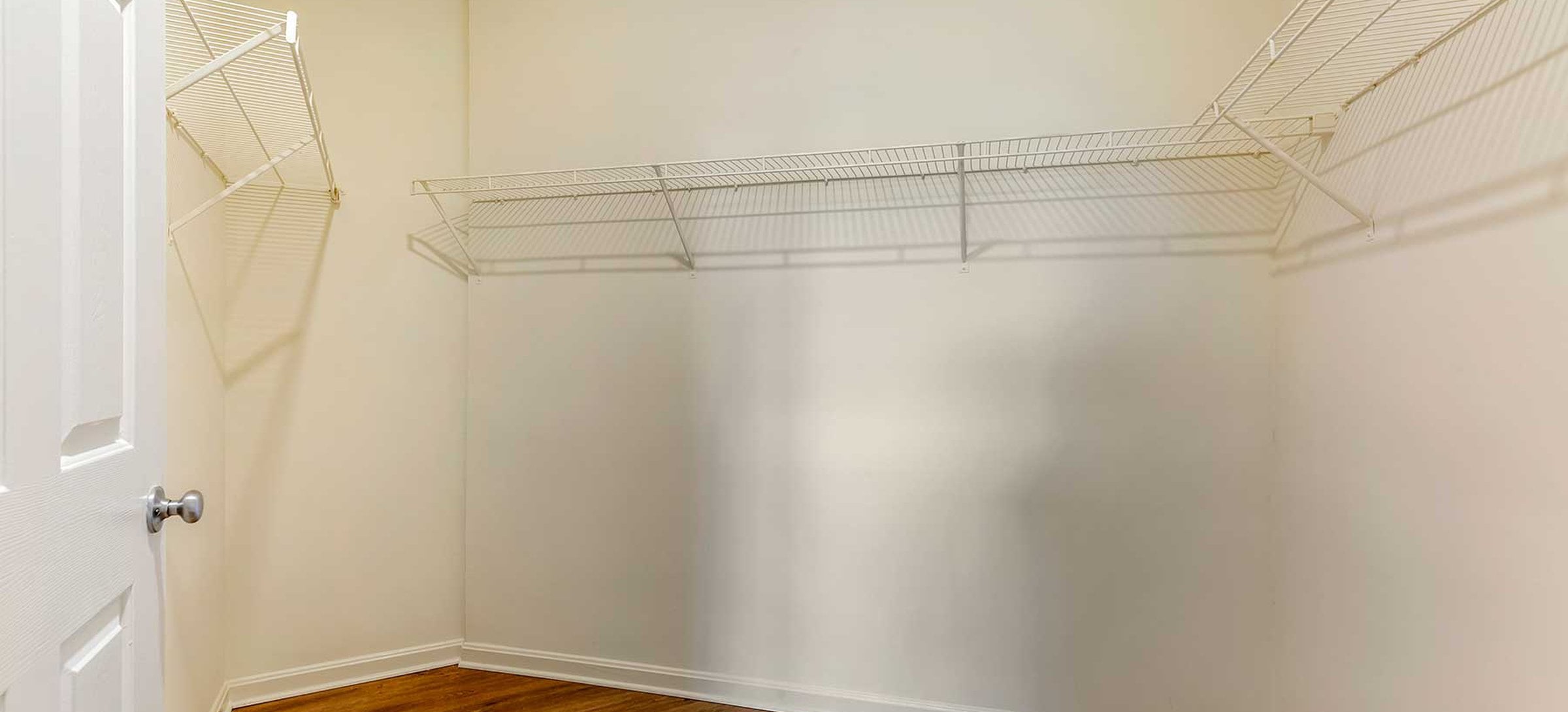 Walk-in closet with linen racks and storage space