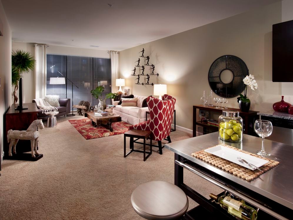 Open concept kitchen with movable island and living area with carpet