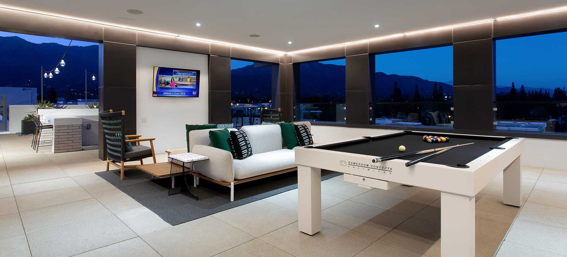 Rooftop indoor lounge with game area and lounge seating