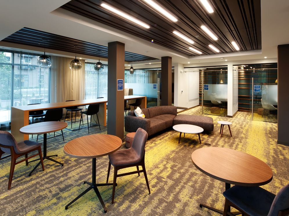 Phase II Hive Co-Work Lounge with separate seating areas and private office spaces, perfect for working remote