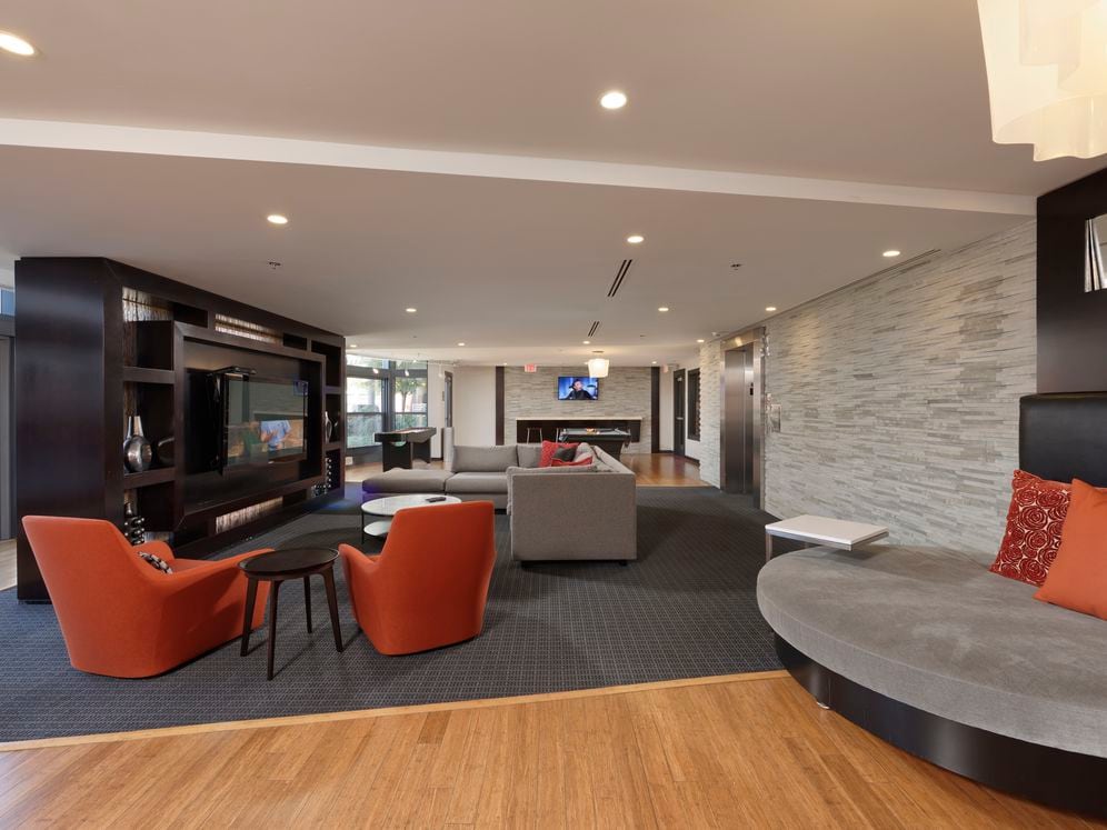 Resident lounge with billiards, shuffleboard, seating and flat screen televisions