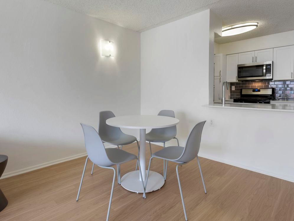 Furnished+ apartment homes include a dining set (Representative Image – exact items and style of furnishings may vary)
