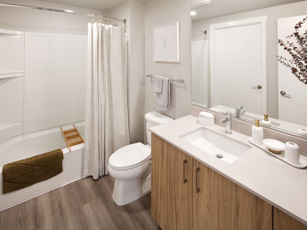 Design Collection II Bath with oak cabinetry, white quartz countertop, and hard surface flooring