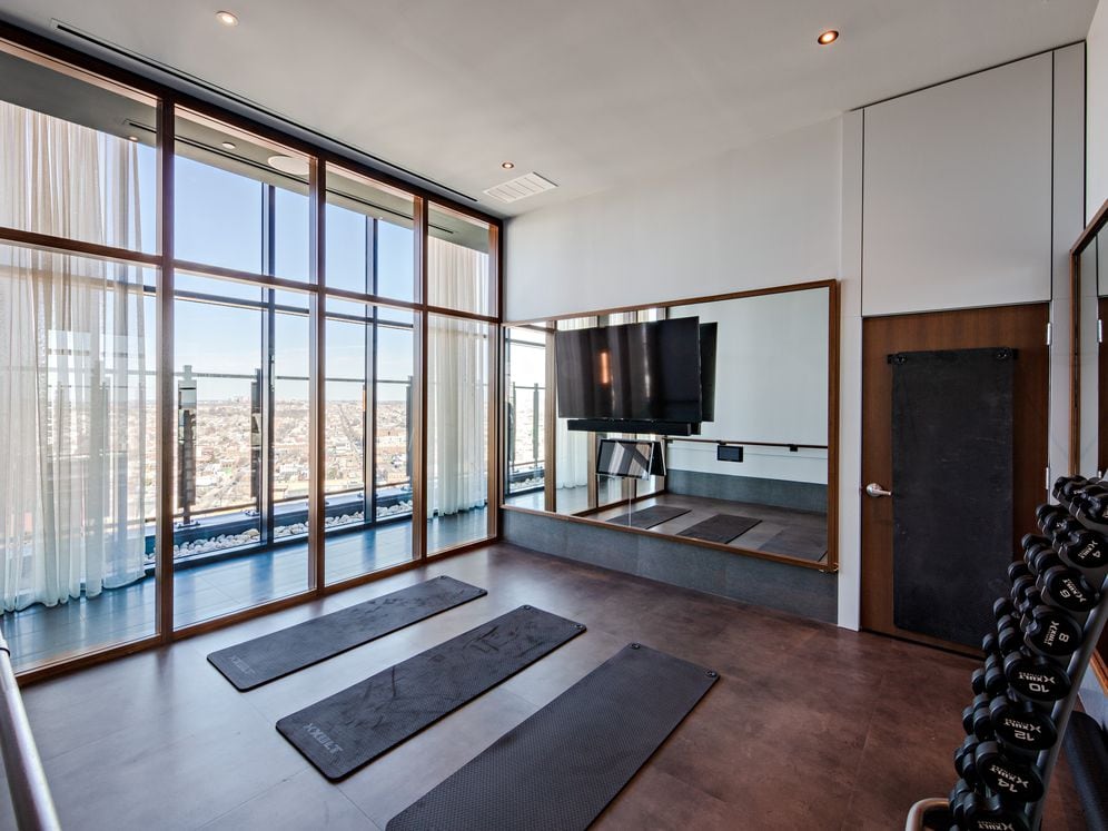 Fitness studio with yoga/stretching area and barre