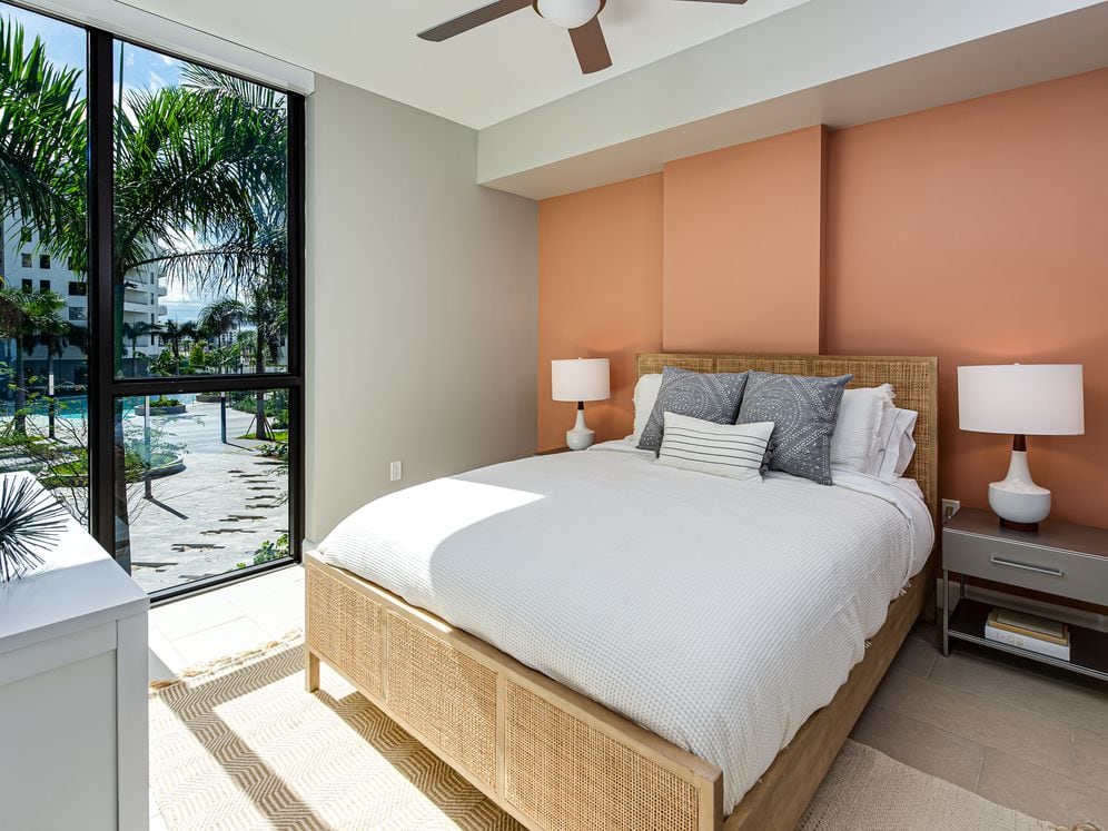 Spacious bedroom with hard surface flooring and ceiling fan