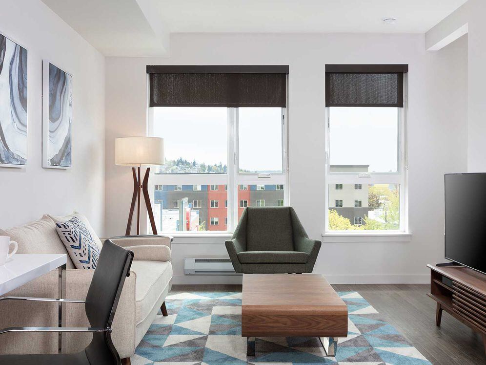 Furnished+ apartment homes come outfitted with a sofa, side chair, side table, coffee table, TV stand and 50" Television (Representative Image – exact items and style of furnishings may vary)