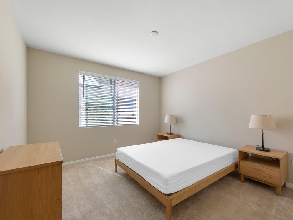 Furnished+ apartment homes feature queen bed with mattress, dresser, nightstands, and lamps (Representative Image – exact items and style of furnishings may vary)