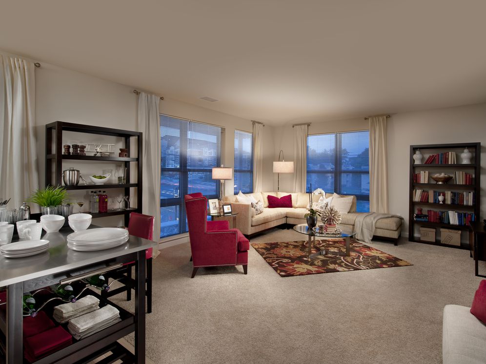 Open concept kitchen with movable island and living area with carpet