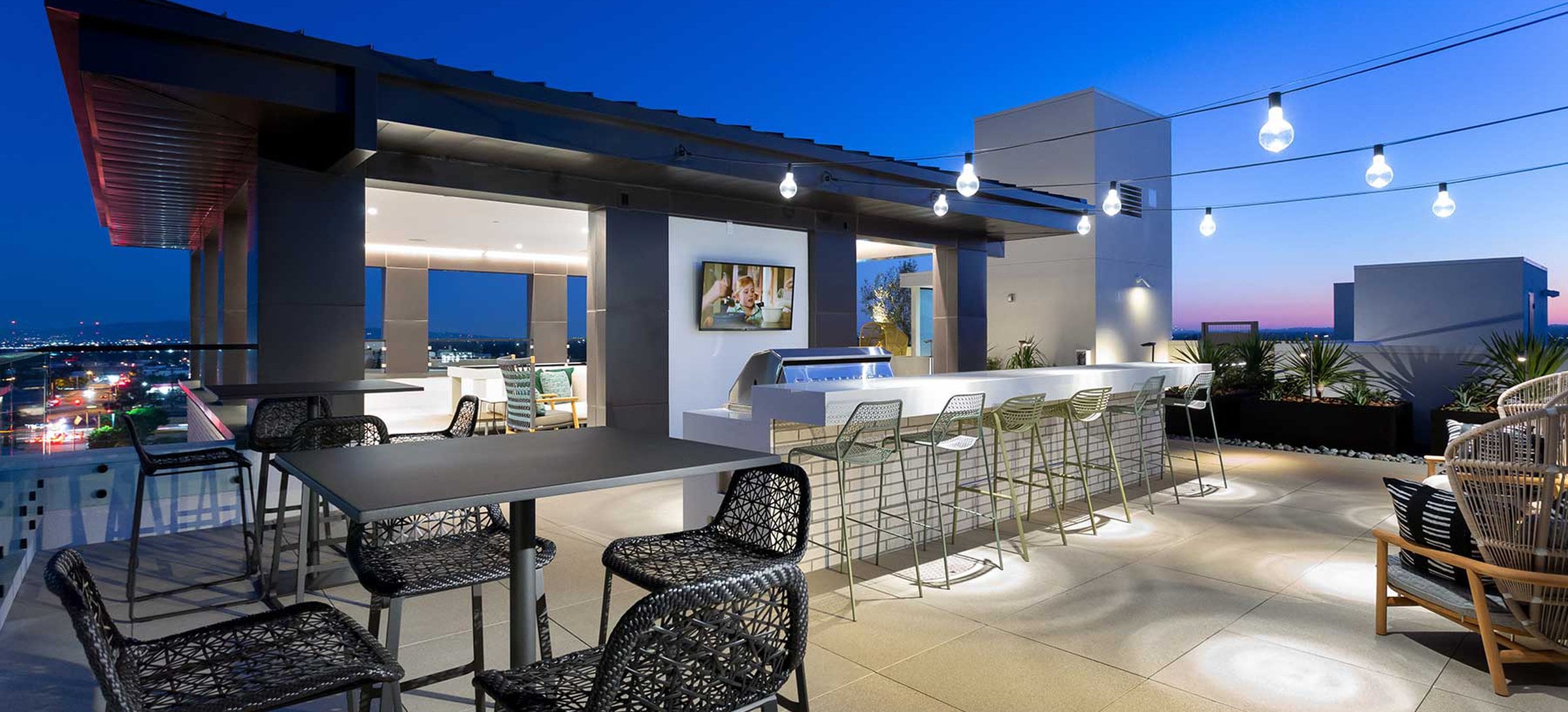 Rooftop terrace with grills, seating and dining areas