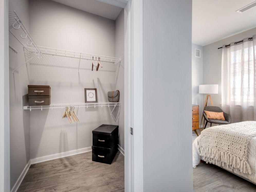 Walk-in closet with linen racks and storage space