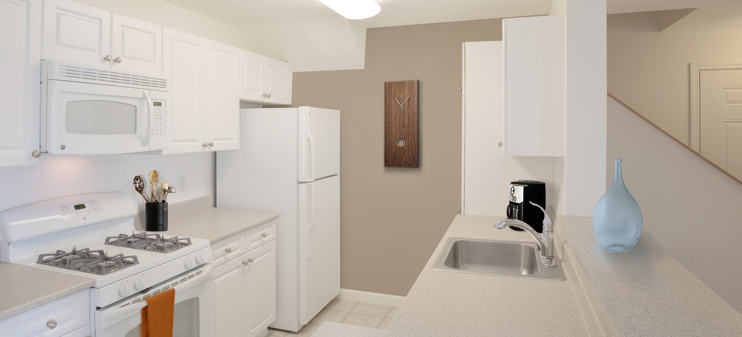 Phase I Classic Package I kitchen with white cabinetry and white appliances 