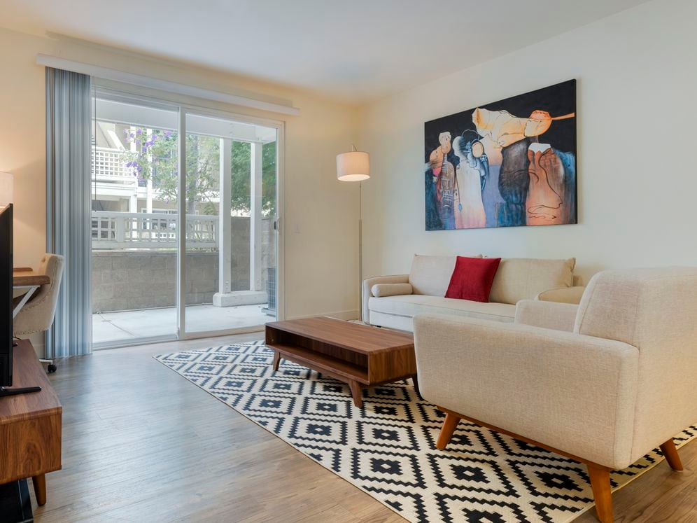 Furnished+ apartment homes come outfitted with a sofa, side chair, side table, coffee table, TV stand and 50" Television (Representative Image – exact items and style of furnishings may vary)